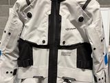 a white jacket with black and blue accents on display