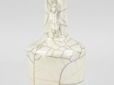 a white vase with a black and white design on it