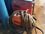 an image of a couple of welding equipment sitting on top of a cement floor