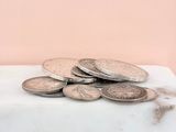 a pile of coins sitting on top of a marble counter