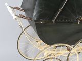 a black baby carriage with a black umbrella on top of it
