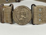 a belt with a coin on it that is attached to a belt