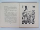 an open book with a drawing of a group of people sitting at a table