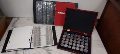 a lot of silver coins in a case on the counter