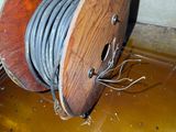 a wooden spool with a wire on top of it