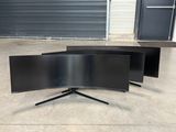 three curved tvs sitting on top of each other in front of a garage