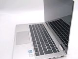 a silver laptop computer sitting on top of a white table