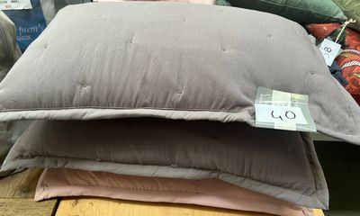three pillows stacked on top of each other on a table