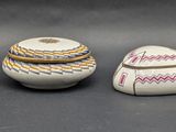 three white bowls with designs on them sitting next to each other on a table