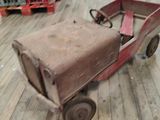 a small toy truck that is sitting on a wooden floor