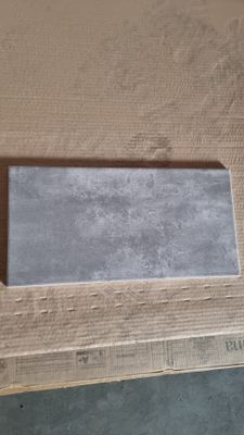 a picture of a piece of cardboard with a piece of cement in it