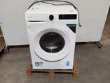a washing machine sitting on a pallet in a room