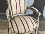 a white chair with a red and white striped seat