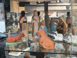 many figurines of animals on display in a glass case