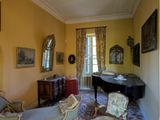 a living room with a piano and a chair in it