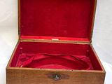 a wooden box with a red cloth inside of it