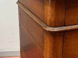 a wooden dresser with a drawer on top of it