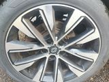 the tire of a black car is shown on the pavement