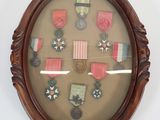 a picture of a picture of a medal display in a wooden frame