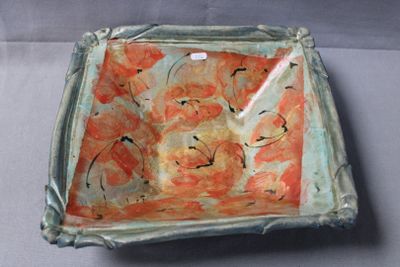 a bowl with a flower design on it on a table
