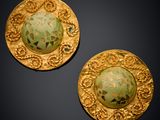 pair of green and gold earrings with floral designs