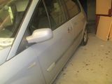 une voiture garée dans un garage à côté d'une pile de cartons