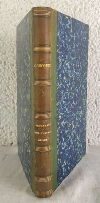 an old book sitting on top of a table next to a white wall