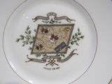 a plate with a picture of a coat of arms on it