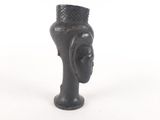a black vase with a head on it on a white background