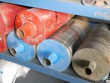 many different types of hoses on a blue shelf