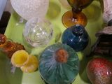 a green tray with glass vases and other items on it