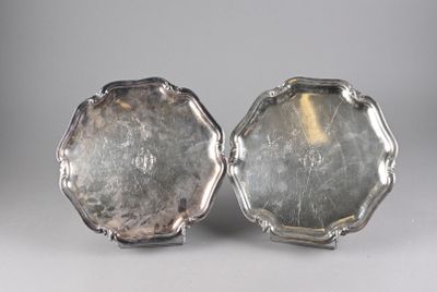 pair of silver plated trays on stand on grey background