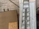 a ladder that is leaning against a wall next to a door