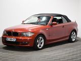 an image of a red bmw convertible parked on a checkered floor
