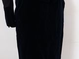 a woman in a black dress and jacket on a mannequin mannequin mannequin mannequin mannequin mannequin mannequin mann
