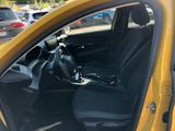 a yellow car with black seats in a parking lot