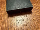 a small black box on a wooden table