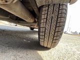 a close up of a car tire on the road