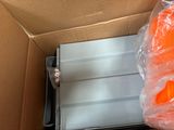 a box that has a bunch of orange plastic items inside of it