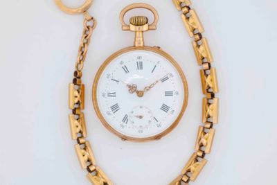 a gold pocket watch with roman numerals on it