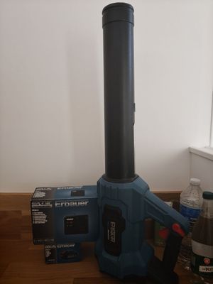 a blue blower sitting on a wooden floor next to a bottle of water
