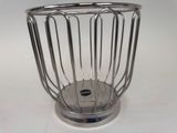 a metal basket with a handle on a white table