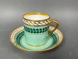 a close up of a cup and saucer on a table