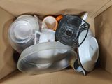 a cardboard box with a blender and other items inside of it