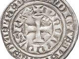 an old silver coin with a cross on it