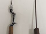 two fishing rods and a hook on a white surface