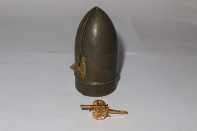 an image of a miniature helmet and a key on a white surface