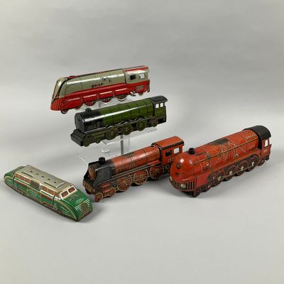 four different types of toy trains on a white surface