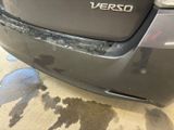 the rear end of a car with a denting dent on it