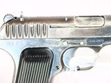 a gun that is sitting on a white surface